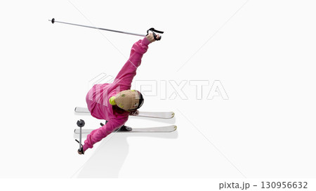 Skier in pink hoodie extending arms dramatically during freestyle motion Skier in pink hoodie extending arms dramatically during freestyle motion 130956632