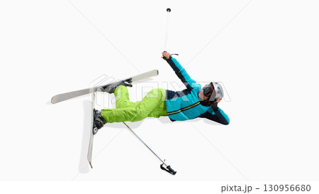 Female skier lying on snow after fall with expressive gesture isolated on white Female skier lying on snow after fall with expressive gesture isolated on white 130956680