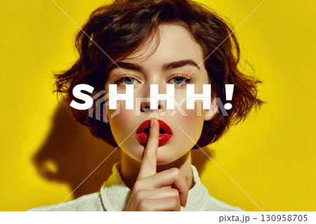 Woman showing silence gesture with shhh text on yellow background 130958705