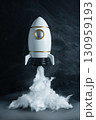Toy rocket with dense smoke at its base, simulating liftoff, concept of imagination, adventure, and space exploration. 130959193