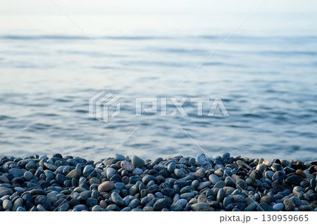 Nature seascape sea background with pebble beach and sea waves in blue colors. 130959665