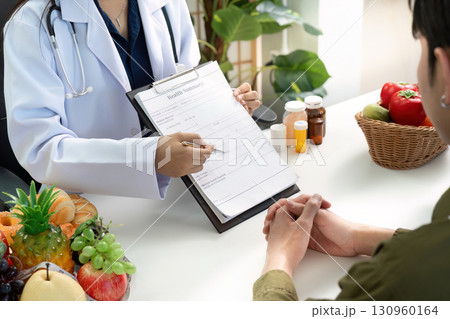 Nutrition Consultation. Healthcare professional advising patient on healthy food choices. 130960164