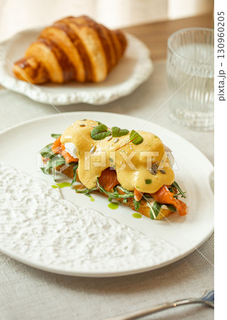 Bruschetta with salmon and croissant served nearby 130960205