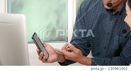 Call Center Agents Discussing Customer Solutions via Smartphone Call Center Agents Discussing Customer Solutions via Smartphone 130961002