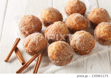 Close-up of sweet cinnamon muffin donuts baked, not fried. Horizontal 130961173