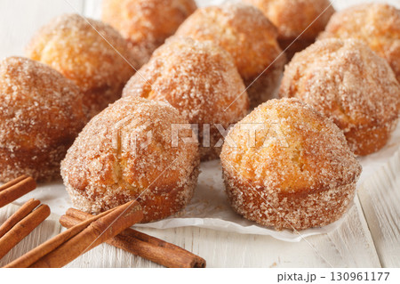 Freshly baked French Breakfast Puff muffins rolled in melted butter and coated with cinnamon sugar close-up. Horizontal Freshly baked French Breakfast Puff muffins rolled in melted butter and coated with cinnamon sugar close-up. Horizontal 130961177