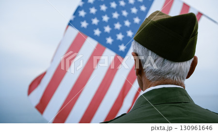Old Veteran Soldier Looking Up At The USA Flag 130961646