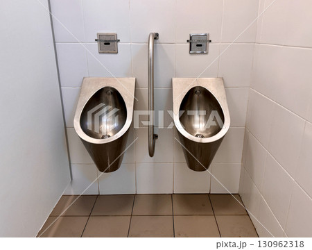 The sleek, modern, and hygienic design of stainless steel urinals is ideal for use in public bathrooms and toilets. 130962318