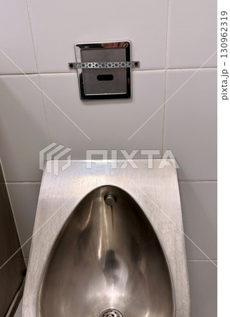 The sleek, modern, and hygienic design of stainless steel urinals is ideal for use in public bathrooms and toilets. 130962319
