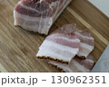 Ukrainian traditional cuisine. Very tasty pieces of salo. Raw ukrainian bacon or salo on wooden board. Sliced salted pork lard (salo). Food concept. 130962351