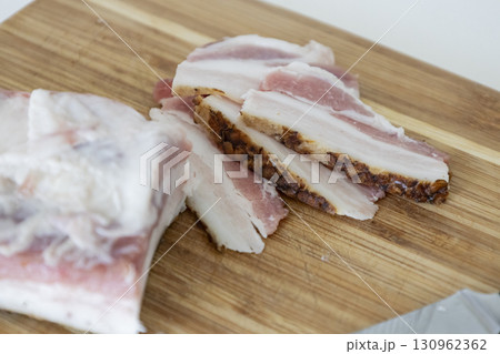Ukrainian traditional cuisine. Very tasty pieces of salo. Raw ukrainian bacon or salo on wooden board. Sliced salted pork lard (salo). Food concept. 130962362
