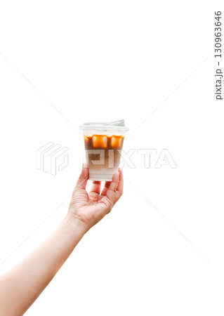 Woman hand holding iced coffee isolated on white background. Woman hand holding iced coffee isolated on white background. 130963646