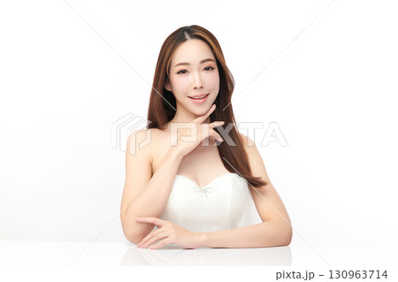 A beautiful young Asian woman with clean, fresh skin against a white background. Skincare, facial treatment, cosmetology, beauty, and spa. An elegant portrait of an Asian woman. 130963714