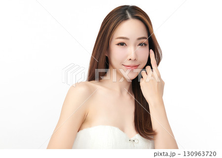 A beautiful young Asian woman with clean, fresh skin against a white background. Skincare, facial treatment, cosmetology, beauty, and spa. An elegant portrait of an Asian woman. 130963720