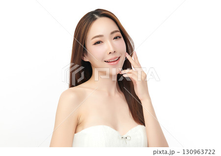 A beautiful young Asian woman with clean, fresh skin against a white background. Skincare, facial treatment, cosmetology, beauty, and spa. An elegant portrait of an Asian woman. 130963722