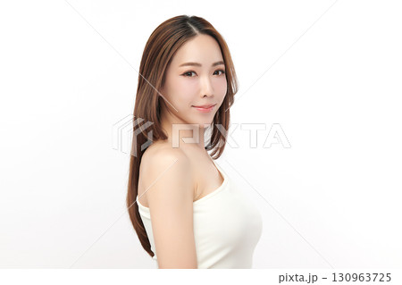 A beautiful young Asian woman with clean, fresh skin against a white background. Skincare, facial treatment, cosmetology, beauty, and spa. An elegant portrait of an Asian woman. 130963725