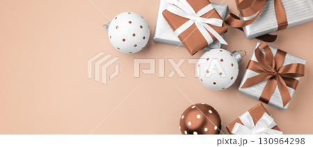Gift boxes, present with brown bow ribbon and christmas ball decor, christmas holiday background, top view Gift boxes, present with brown bow ribbon and christmas ball decor, christmas holiday background, top view 130964298