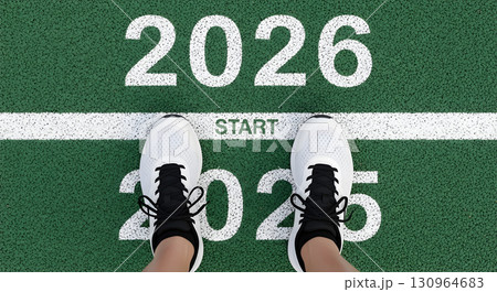The start of the year 2026 with shoes on a green surface and a white line. The start of the year 2026 with shoes on a green surface and a white line. 130964683