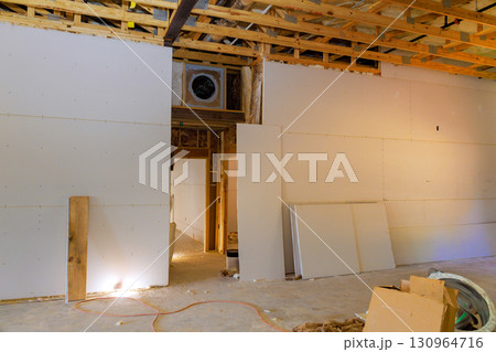 Construction progress in residential building showing framed wall drywall installation 130964716