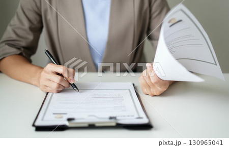 Business woman employer holding resume hiring recruit looking cv resume to hire candidates, analyzing information before job interview. Recruitment concepts Business woman employer holding resume hiring recruit looking cv resume to hire candidates, analyzing information before job interview. Recruitment concepts 130965041