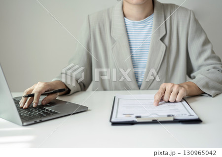 Business woman employer holding resume hiring recruit looking cv resume to hire candidates, analyzing information before job interview. Recruitment concepts Business woman employer holding resume hiring recruit looking cv resume to hire candidates, analyzing information before job interview. Recruitment concepts 130965042