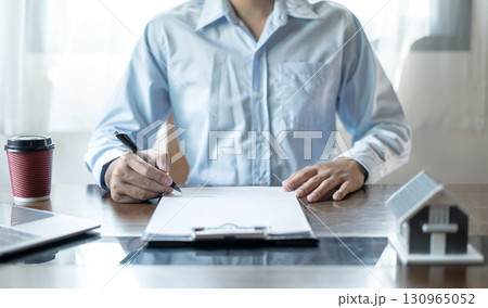 cagents working in real estate investment and home insurance signing contracts in accordance with the home buying insurance agreements approving purchases for clients 130965052