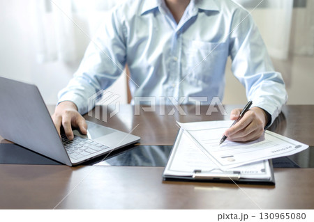 Business man employer holding resume hiring recruit looking cv resume to hire candidates, analyzing information before job interview. Recruitment concepts 130965080