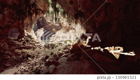 A breathtaking view inside a cave showcases rugged rock formations illuminated by sunlight filtering through lush green plants, creating a serene atmosphere. A breathtaking view inside a cave showcases rugged rock formations illuminated by sunlight filtering through lush green plants, creating a serene atmosphere. 130965321