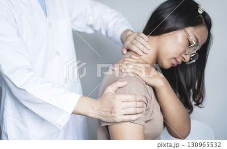 Female physiotherapists provide physical assistance to woman patients with shoulder injuries massaging their shoulders for muscle recovery in the rehabilitation center. Physiotherapy concepts Female physiotherapists provide physical assistance to woman patients with shoulder injuries massaging their shoulders for muscle recovery in the rehabilitation center. Physiotherapy concepts 130965532
