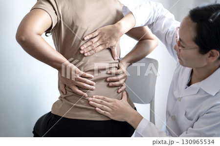 Female patients consulted physiotherapists with Low back pain for examination and treatment. Rehabilitation physiotherapy concept 130965534