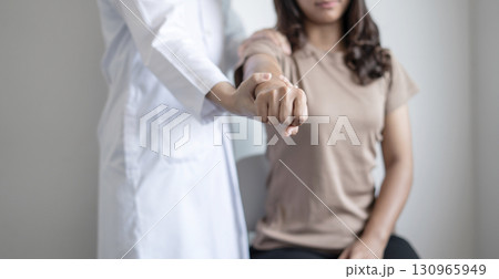 Female physiotherapists provide physical assistance to woman patients with shoulder injuries massaging their shoulders for muscle recovery in the rehabilitation center. Physiotherapy concepts 130965949