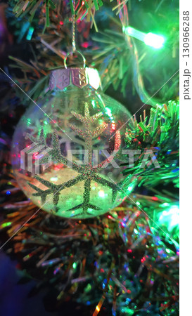 Christmas tree decorated with beautiful transparent ball with abstract snowflake Christmas tree decorated with beautiful transparent ball with abstract snowflake 130966288