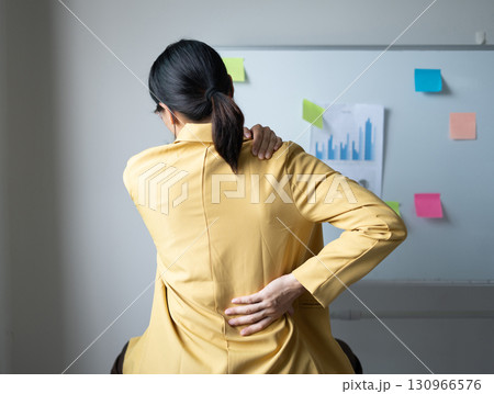 Woman having back and shoulder pain pain during work long time. stretching to relax and relax while working hard at the office Woman having back and shoulder pain pain during work long time. stretching to relax and relax while working hard at the office 130966576