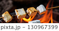 Enjoying toasted marshmallows over a bright campfire Generative AI 130967399