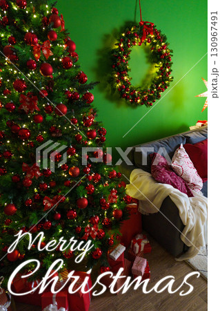 Festive Christmas tree with decorations and cozy couch in a cheerful room 130967491