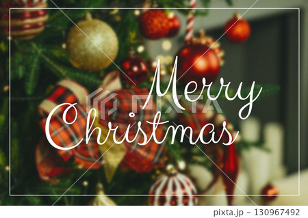 Merry Christmas decorations featuring ornaments and ribbons on a festive tree Merry Christmas decorations featuring ornaments and ribbons on a festive tree 130967492