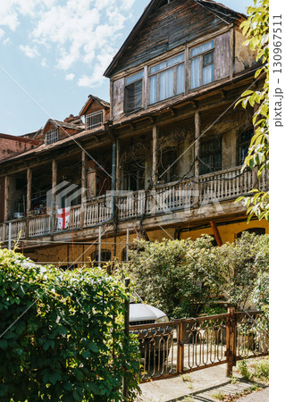 Historic wooden house with balcony details and an English flag in the heart of a vibrant neighborhood 130967511