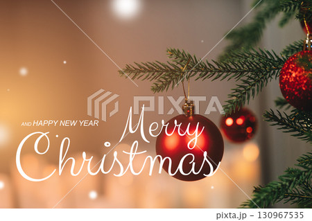 Christmas tree decoration with red ornaments and a festive greeting in soft lighting 130967535