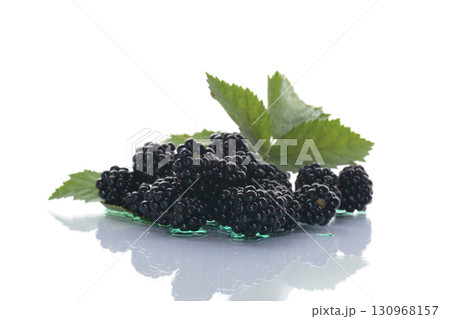 Ripe blackberries with green leaves on a white background Ripe blackberries with green leaves on a white background 130968157