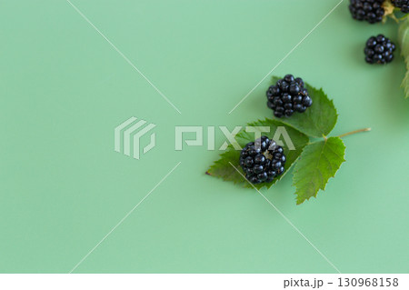 Ripe blackberries with green leaves, top view Ripe blackberries with green leaves, top view 130968158