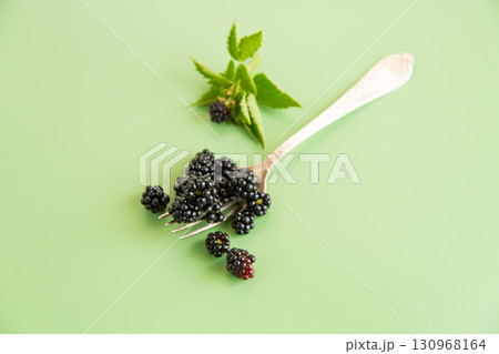 Black blackberries with greenery, top view Black blackberries with greenery, top view 130968164