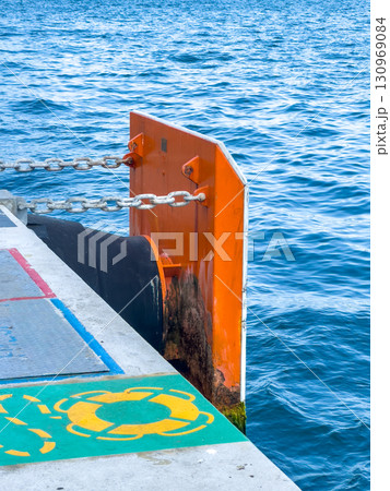Protective board and mooring rope at the pier by the sea 130969084