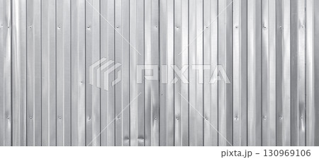A textured shiny metal wall with vertical corrugated patterns A textured shiny metal wall with vertical corrugated patterns 130969106