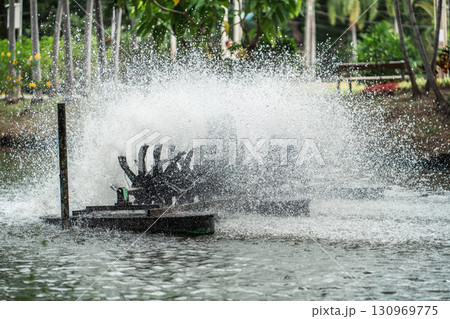 rotating water oxygen generator in park creating droplets, eco-friendly aeration device in pond producing dynamic water splashes, Lumpini park, Bangkok rotating water oxygen generator in park creating droplets, eco-friendly aeration device in pond producing dynamic water splashes, Lumpini park, Bangkok 130969775