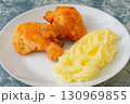 Fried breaded chicken leg with mashed potatoes on plate 130969855