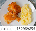 Fried breaded chicken leg with mashed potatoes on plate 130969856