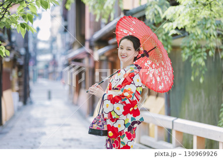 和傘を持った着物姿の若い女性 130969926