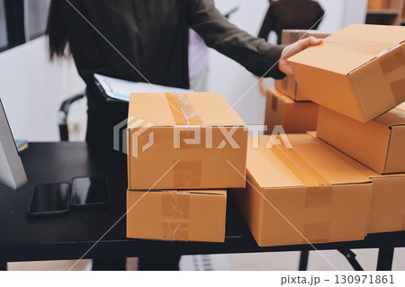 Portrait of Starting small businesses SME owners, two Asian woman check online orders Selling products working with boxs freelance work at home office, sme business online small medium enterprise Portrait of Starting small businesses SME owners, two Asian woman check online orders Selling products working with boxs freelance work at home office, sme business online small medium enterprise 130971861