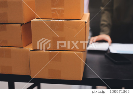 Portrait of Starting small businesses SME owners, two Asian woman check online orders Selling products working with boxs freelance work at home office, sme business online small medium enterprise Portrait of Starting small businesses SME owners, two Asian woman check online orders Selling products working with boxs freelance work at home office, sme business online small medium enterprise 130971863