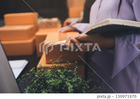 Portrait of Starting small businesses SME owners, two Asian woman check online orders Selling products working with boxs freelance work at home office, sme business online small medium enterprise Portrait of Starting small businesses SME owners, two Asian woman check online orders Selling products working with boxs freelance work at home office, sme business online small medium enterprise 130971870